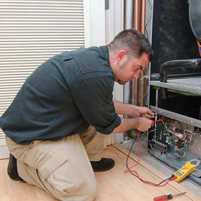 HVAC technician working on a residential heat pump