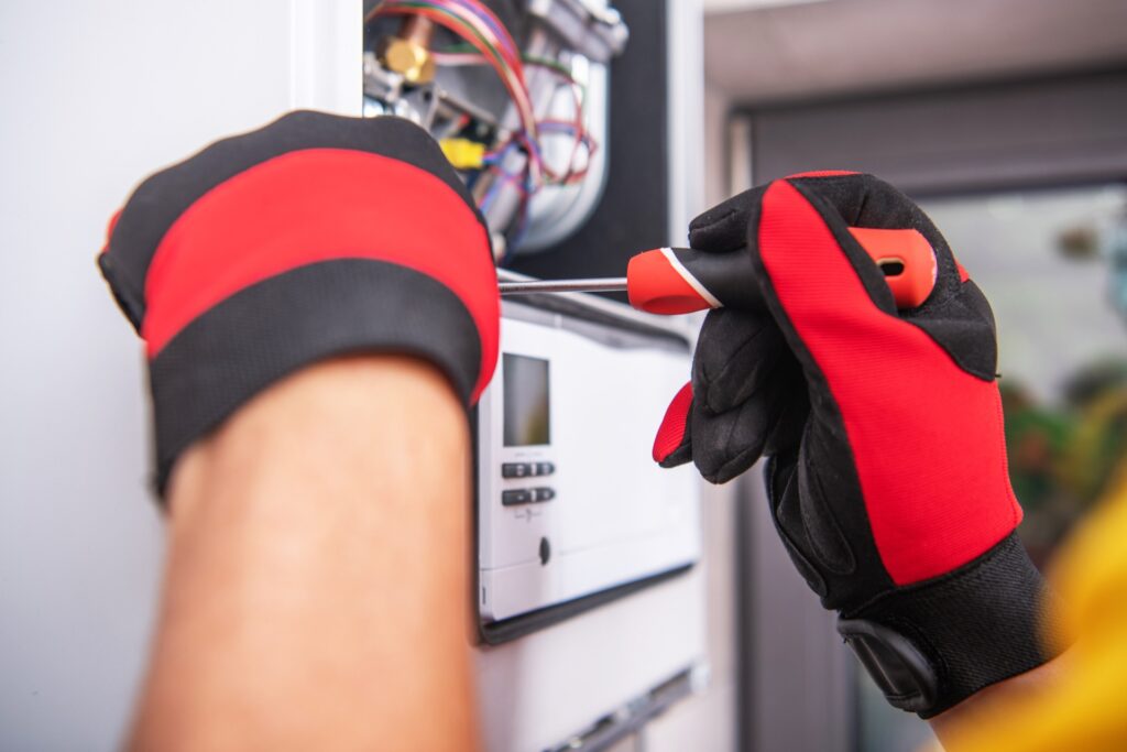 HVAC Technician Repairs Heater Device