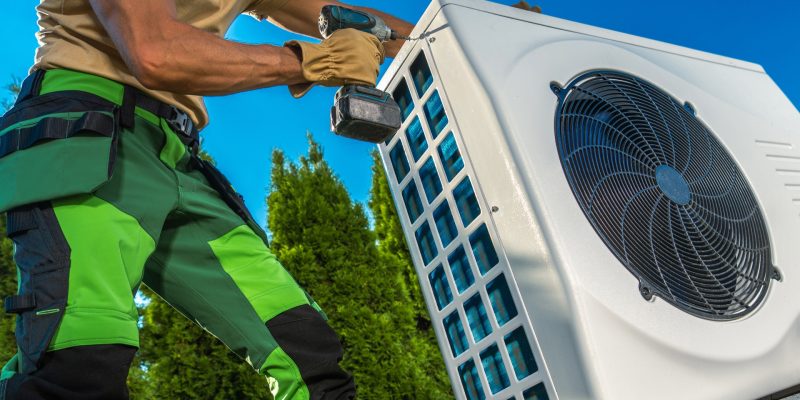 HVAC Technician Installing Heat Pump