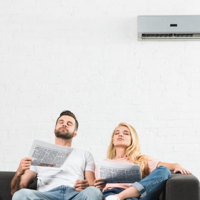 couple under air conditioner at home