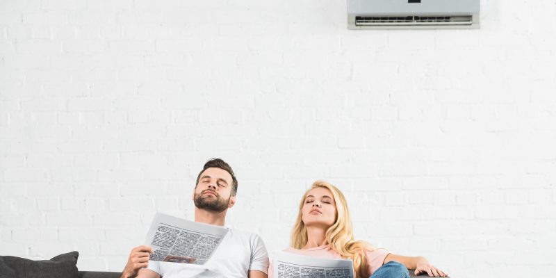 couple under air conditioner at home